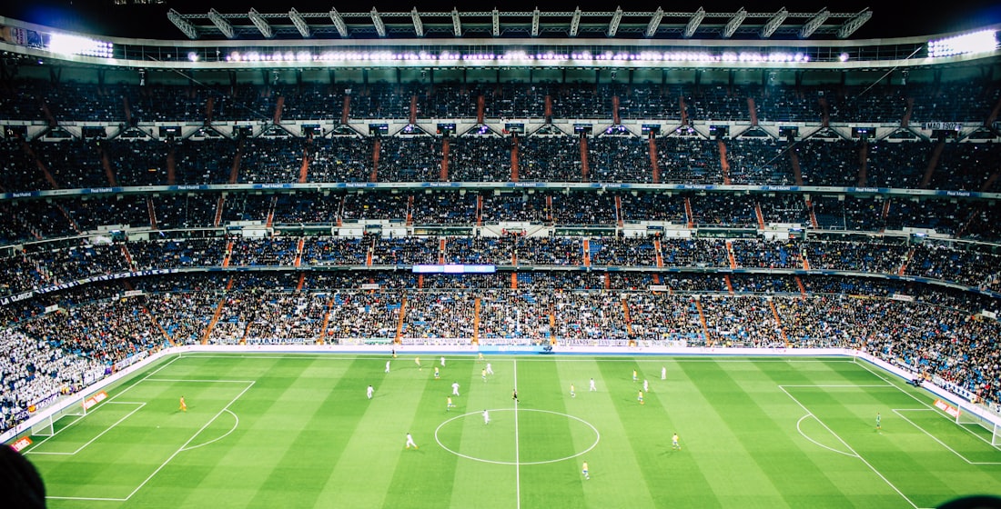 A packed football stadium under floodlights, streamed live on SMARTIFLIX
